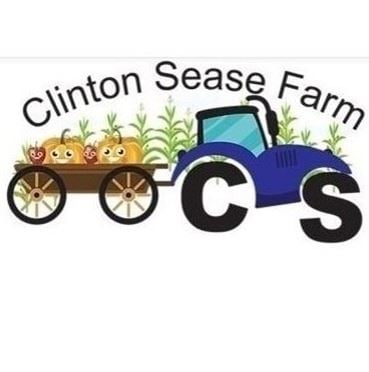 clinton sease farm illustrated blue tractor with wheels made of C and S towing a wagon with smiling pumpkins and strawberries with corn stalks behind it