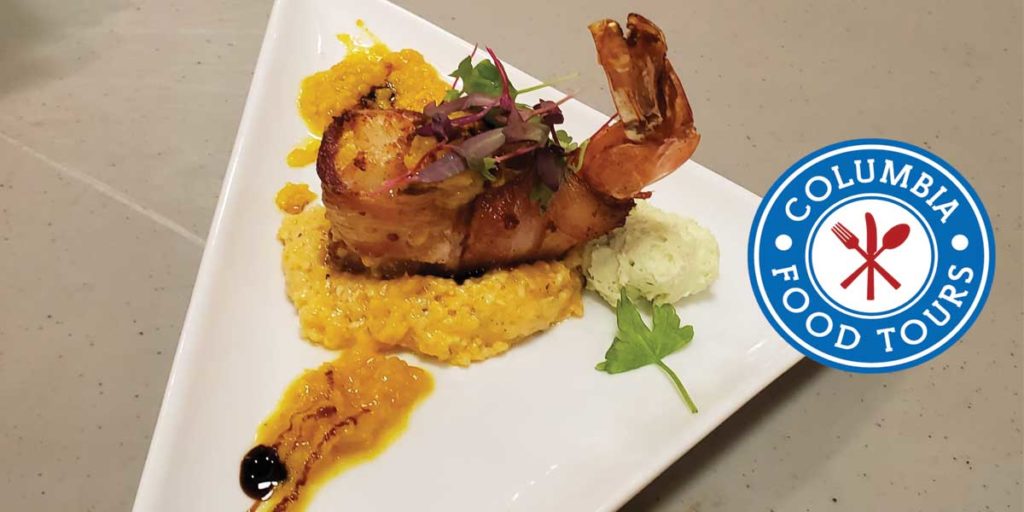 Shrimp Dish on Triangular Plate, Blue Logo Text Reads:"Columbia Food Tours"