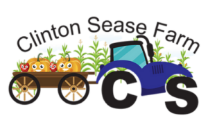 Clinton Seas Farm blue cartoon tractor side view front tire is S and rear tire is C pulling a trailer of smiling pumpkins corn stalks in the background
