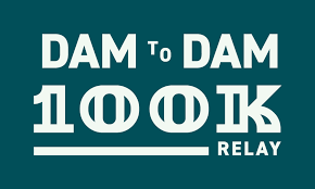 Teal Background, Text Reads: DAM to DAM 100K Relay