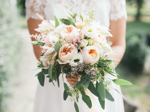 chest high down shot of a bride holding a bouquet of flowers