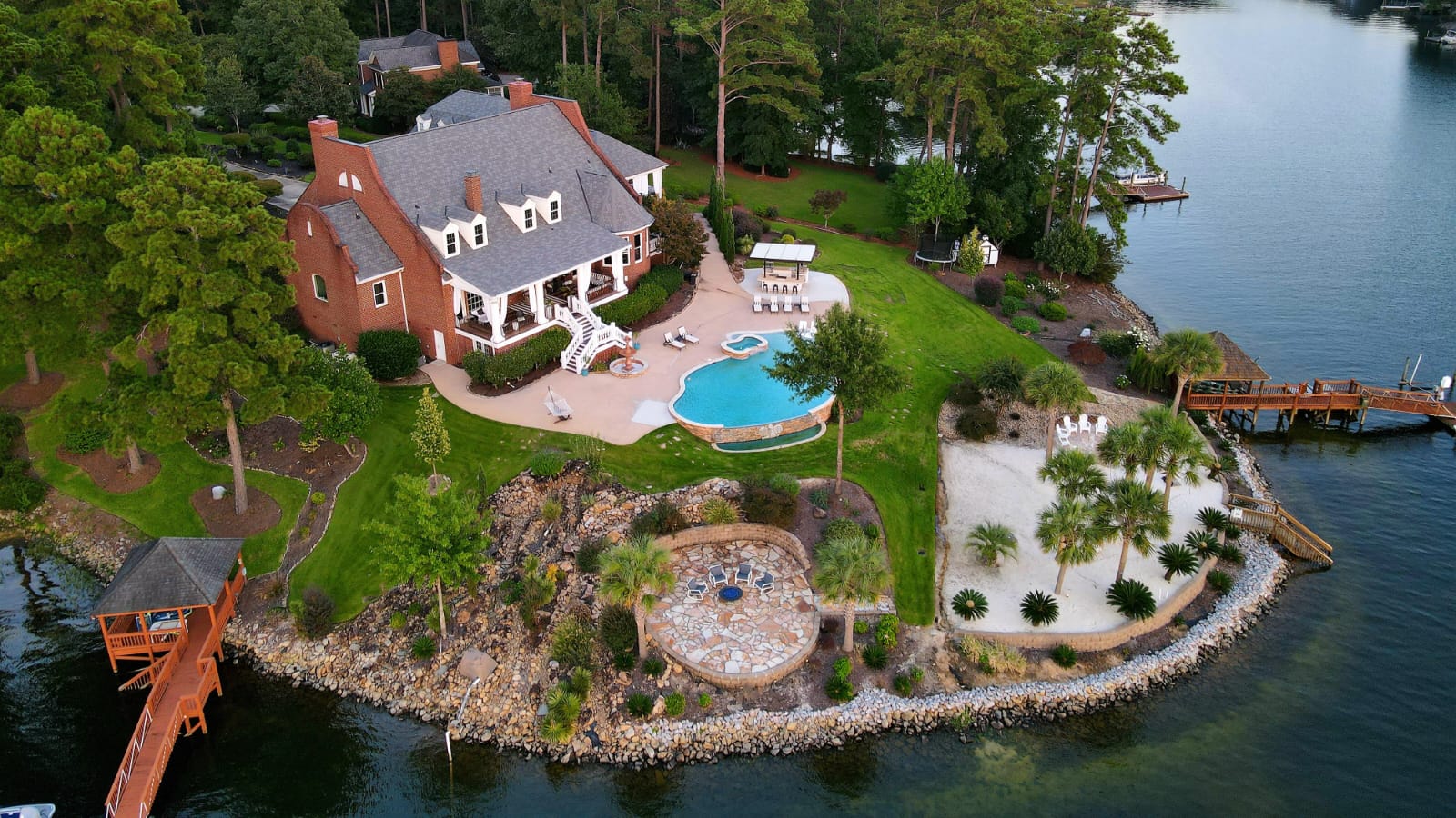 areal view of brick house with pool and private dock overlooking Lake Murray