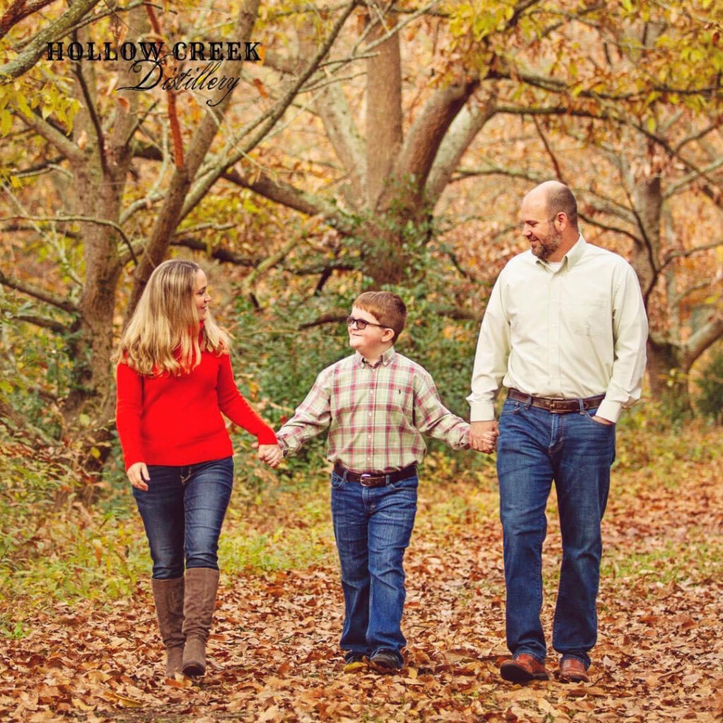 Meredith and Craig Amick walk with their son walking on a fall day