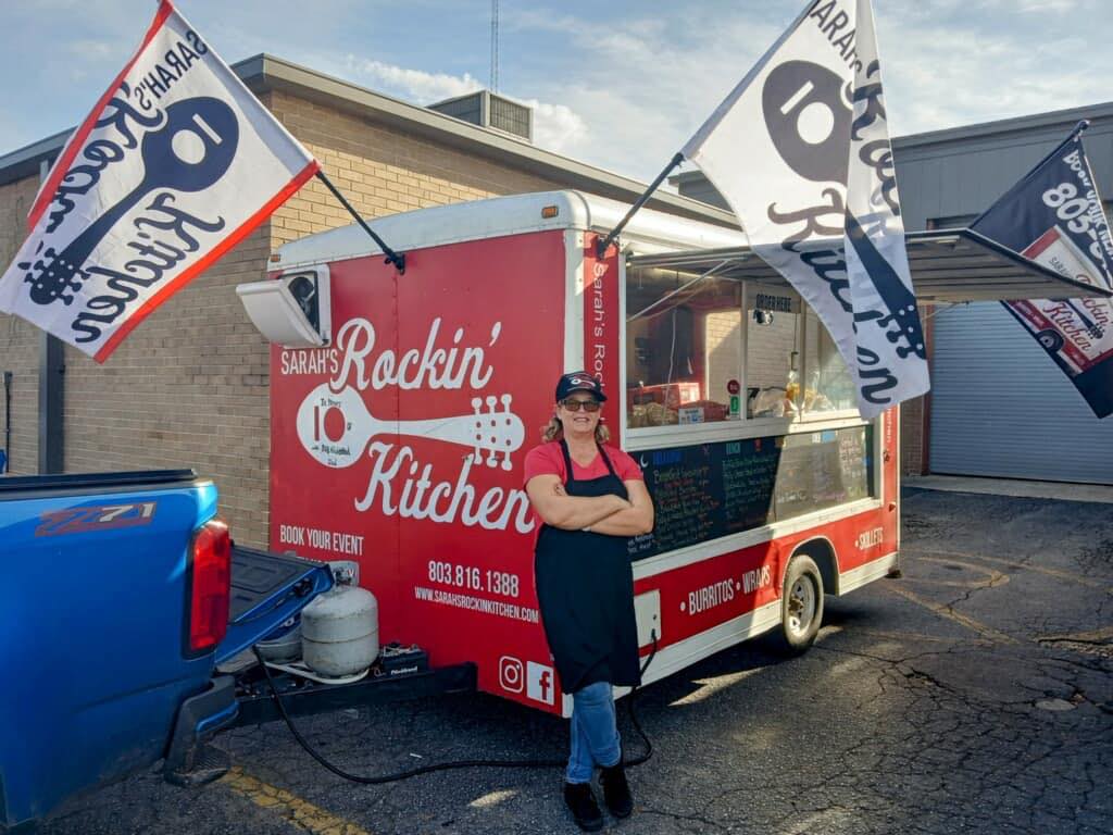 red food truck with flag and woman