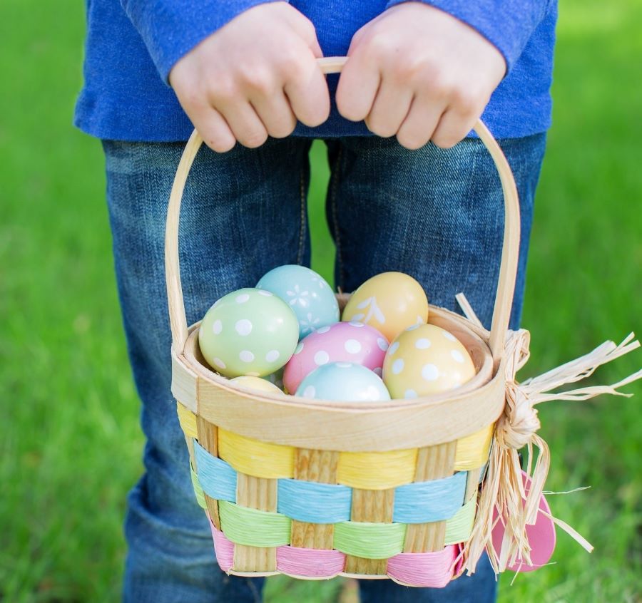 child holding a filled easter basket