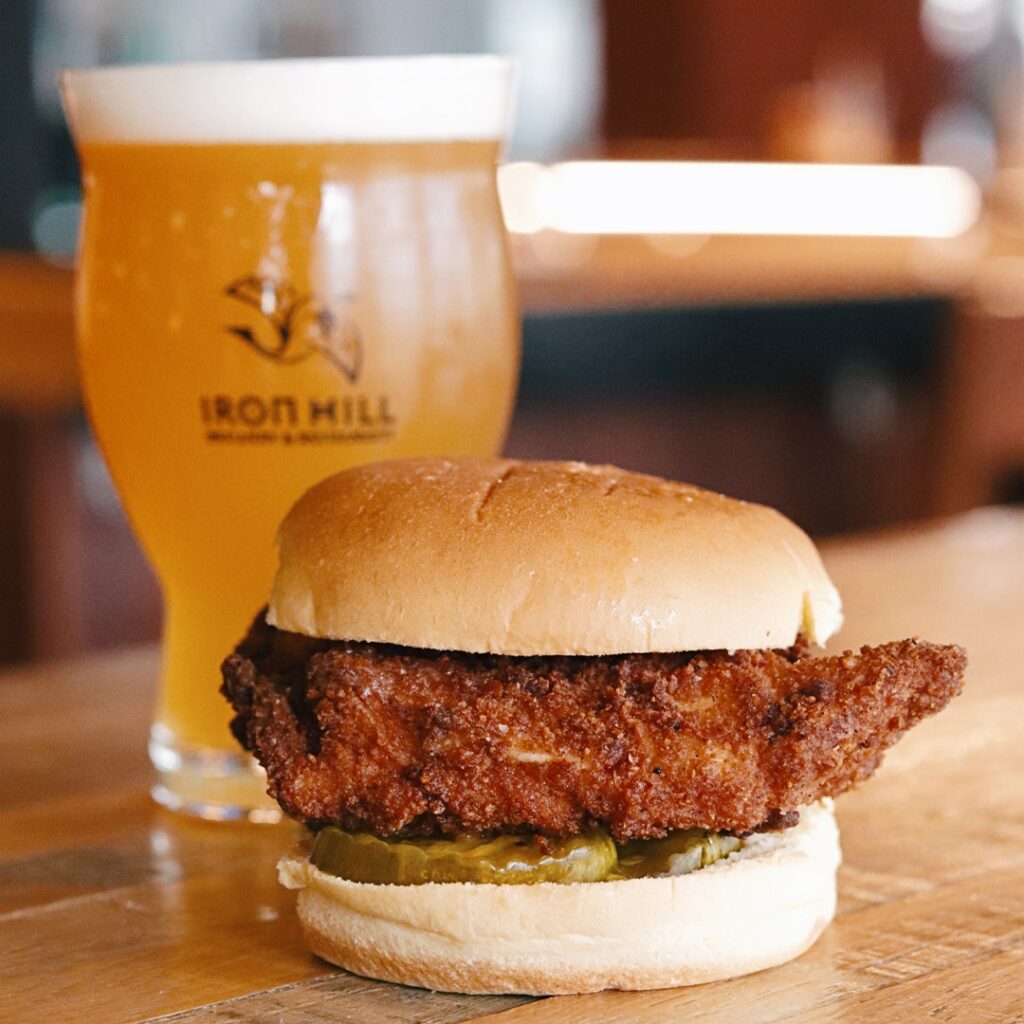Iron Hill Brewery fried chicken sandwich and beer