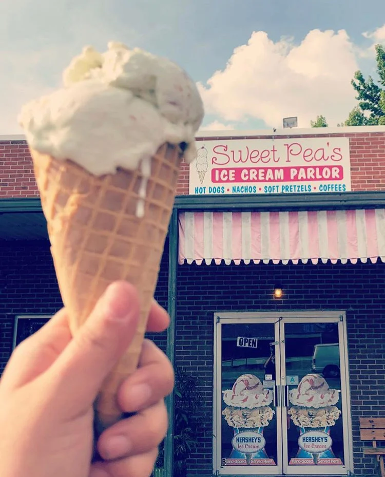 Vanilla ice cream cone outside Sweet Peas Ice Cream Parlor