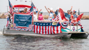 Pontoon boat with American flags, banner sign and blow up American eagle