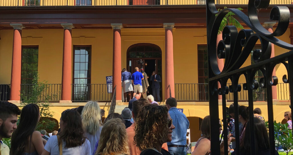 People gathered in line to tour the large, yellow, multi-story house that is the Hampton Preston Mansion with Historic Columbia.