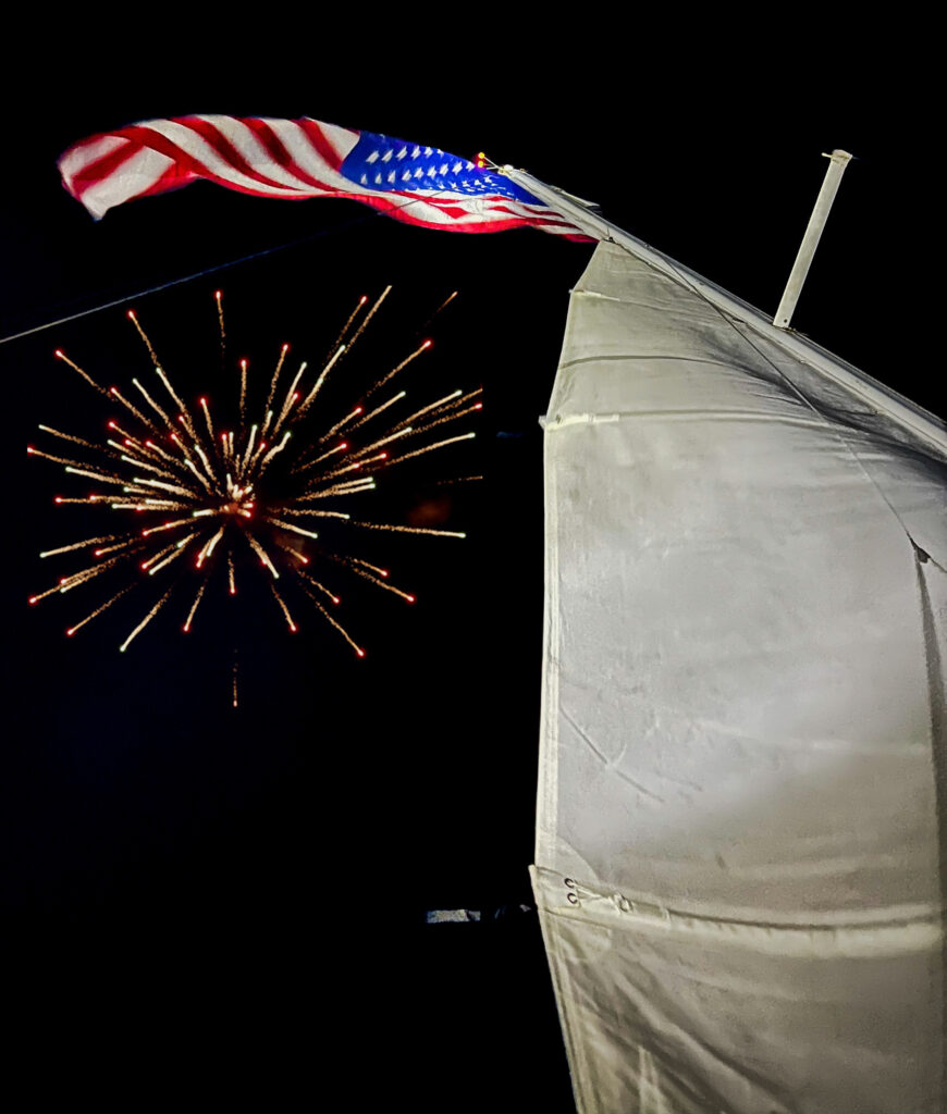 A sailboat on Lake Murray provides a stunning vantage point as fireworks light up the night sky in a dazzling display.