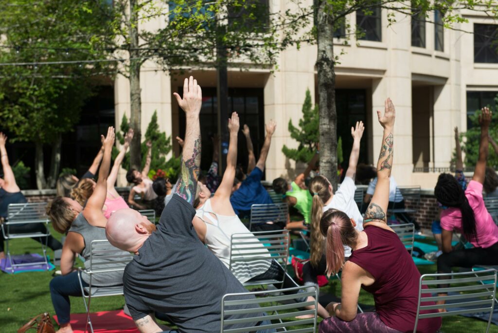 People stretching in yoga poses in Boyd Plaza outside the Columbia Museum of Art in Columbia, SC