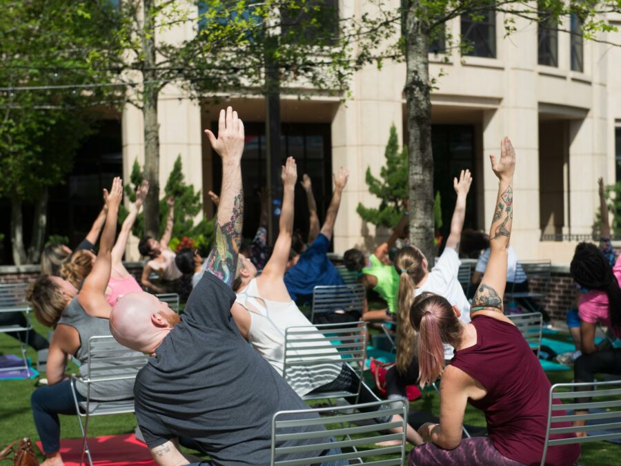 People stretching in yoga poses in Boyd Plaza outside the Columbia Museum of Art in Columbia, SC